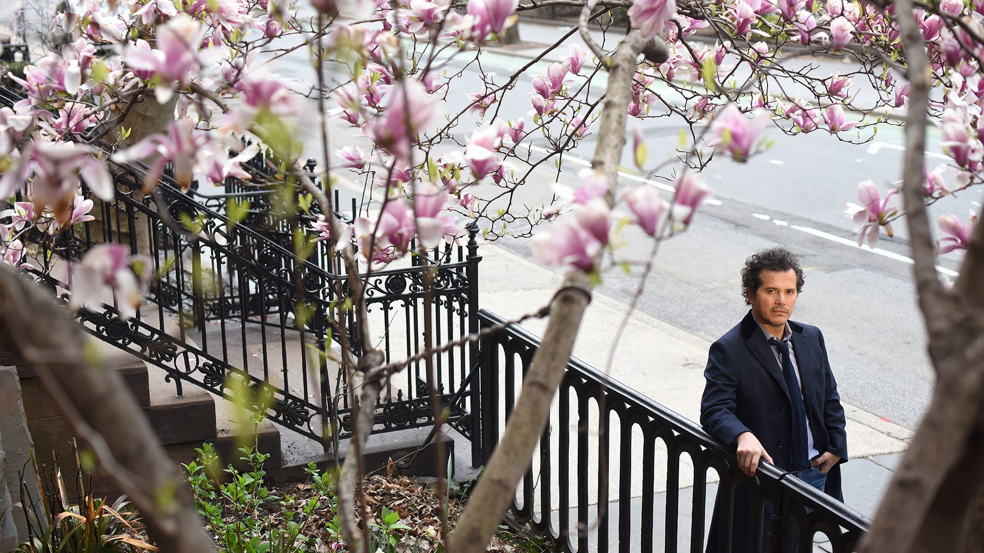 John Leguizamo under cherry blossoms