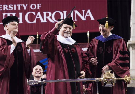 Vartan Gregorian waves to the audience after receiving an honorary doctoral degree at the University of South Carolina commencement exercises