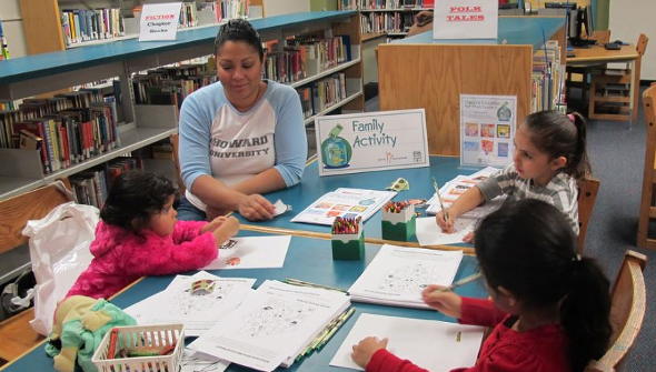 A group of preschoolers participate in coloring activities during a Family Fun Fest at the Main Library. A group of preschoolers participate in coloring activities during a Family Fun Fest at the Main Library.