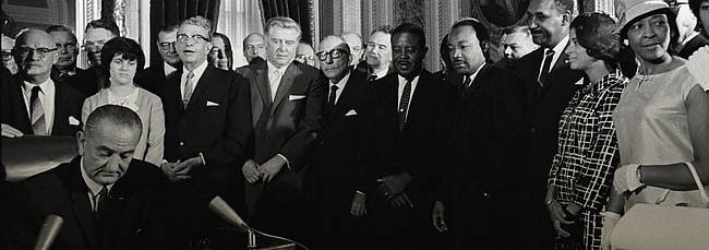 President Lyndon B. Johnson signs the Voting Rights Act as Martin Luther King Jr. and other civil rights leaders look on. LBJ Library Photo by Yoichi Okamoto freedomsummer.jpg